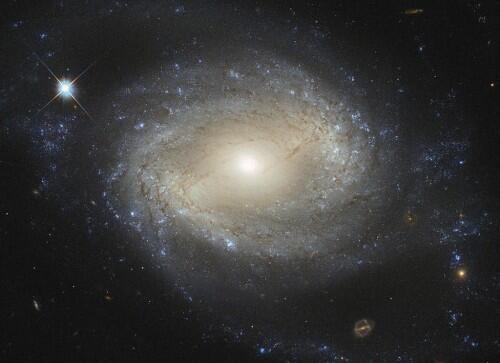 The barred spiral galaxy NGC 4639, which lies over 70 million light-years away in the constellation of Virgo and is one of about 1500 galaxies that make up the Virgo Cluster. NGC 4639 also conceals a massive black hole that is consuming the surrounding gas. REUTERS/ESA/Hubble/NASA