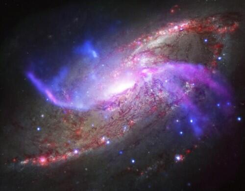 The spiral galaxy NGC 4258, also known as M106, has two extra spiral arms. REUTERS/NASA