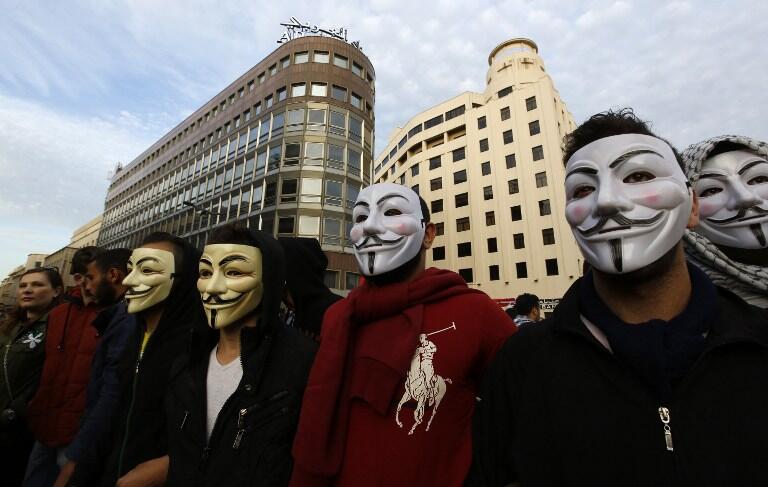 Masked Lebanese protesters take part in a demonstration against the on-going trash crisis and government corruption, in downtown Beirut, on March 12, 2016. Lebanon said it would reopen new landfills as a temporary solution to an eight-month rubbish crisis as thousands of people demonstrated in Beirut against the waste pile-up. Rubbish has piled up on beaches, mountain forests and river beds across Lebanon since the closure in July of the country's largest landfill at Naameh, just south of Beirut. Since then, numerous proposals by the government to export the trash or treat it in Lebanon have fallen flat. / 