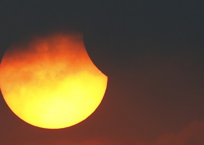 A partial solar eclipse is seen through clouds in Bangkok, Thailand, March 9, 2016. REUTERS/Athit Perawongmetha