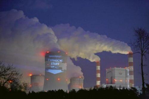 A slogan is projected by Greenpeace activists on a cooling tower of Belchatow Power Station, Europe's largest coal-fired power plant, in Belchatow November 9, 2013. REUTERS/Tomasz Stanczak/Agencja Gazeta