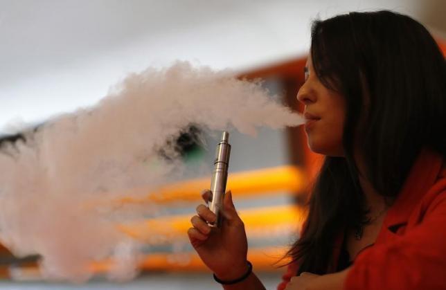 Enthusiast Brandy Tseu uses an electronic cigarette at The Vapor Spot vapor bar in Los Angeles, California March 4, 2014. The Los Angeles City Council voted unanimously on Tuesday to ban the use of electronic cigarettes, popularly known as "vaping," from restaurants, bars, nightclubs and other public spaces within the nation's second-largest city.  REUTERS/Mario Anzuoni