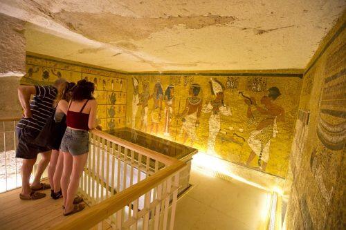 American tourists visit King Tutankhamun's burial chamber at his tomb at the Valley of the Kings in Luxor, Egypt, Thursday, March 31, 2016. A radar surveys is scheduled Thursday by Japanese radar technologist to confirm or deny claims that King Tutankhamun's tomb contains hidden undiscovered chambers. (AP Photo/Amr Nabil)