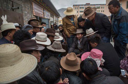 Traders and Tibetan nomads crowd around as they bid on cordycep fungus for sale at a market in YushuKevin Frayer/Getty Images