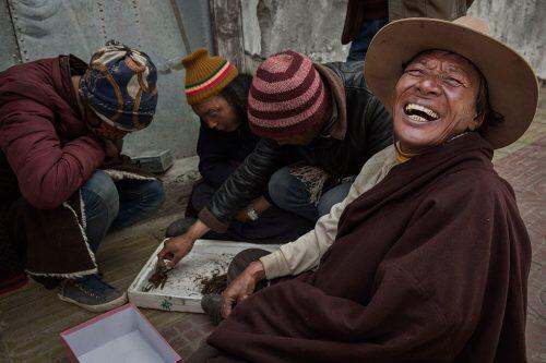 A Tibetan nomad laughs as vendors buy and sell cordycep fungus at a market in SershulKevin Frayer/Getty Images