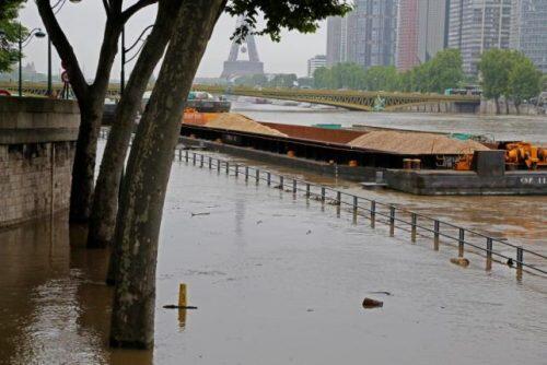 Barges are moored together near the Eiffel Tower as high waters cover the banks of the Seine River in Paris, France, after days of almost non-stop rain caused flooding in the country, June 2, 2016. REUTERS/Jacky Naegelen