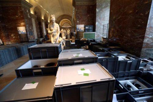 Crates containing pieces of artworks from the collections of the Louvre Museum are seen near statues after the museum was closed to the public due to the rising Seine River in Paris, France, after days of almost non-stop rain caused flooding in the country, June 3, 2016. REUTERS/John Schults