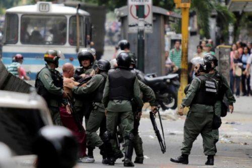 Venezuelan National Guards detain a protester during riots for food in Caracas, Venezuela, June 2, 2016. REUTERS/Marco Bello