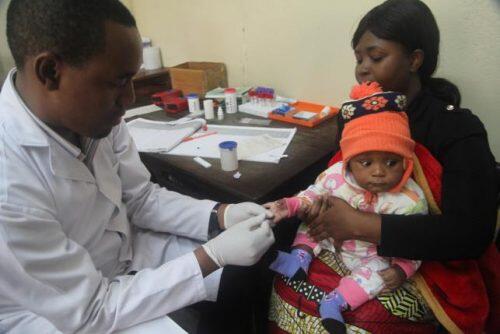 A doctor tests a child for malaria at the Ithani-Asheri Hospital in Arusha, Tanzania, May 11, 2016. REUTERS/Katy Migiro