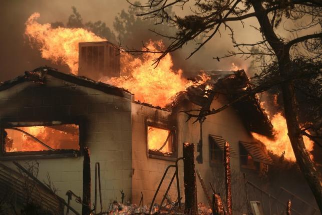 Two killed, 100 homes destroyed by fast-moving California wildfire