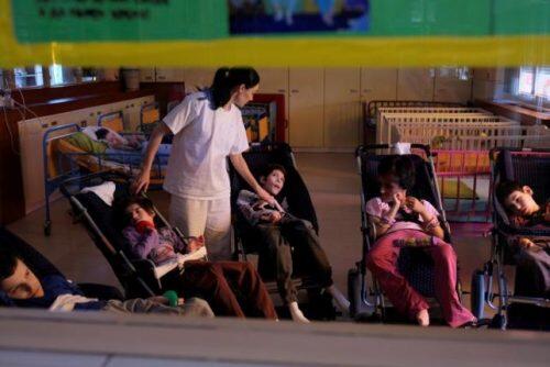 A nurse takes care of children with disabilities at the Centre for the Protection of Infants, Children and Youth in Belgrade, Serbia June 8, 2016.  REUTERS/Marko Djurica