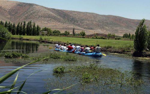 TO GO WITH AFP STORY BY JOCELYNE ZABLIT  Ecotourists row an inflatable boat at a natural reserve in Kfar Zabad in the Bekaa valley on June 14, 2008. A decade ago, it was a glittering vision -- a scheme to lure nature lovers to the Lebanese highlands, providing income to local people, nurturing the country's damaged environment and cementing national unity in one stroke. Today, after a war, a political crisis and flareups of sectarian violence, Lebanon's brave experiment in eco-tourism is battered and bloodied but defiantly soldiers on. AFP PHOTO/RAMZI HAIDAR (Photo credit should read RAMZI HAIDAR/AFP/Getty Images)