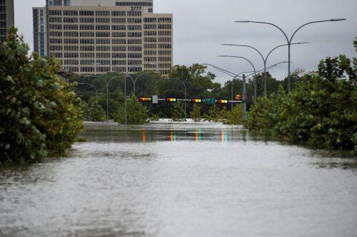 A downtown street is submerged in water from Buffalo Bayou after Hurricane Harvey inundated the Texas Gulf coast with rain causing widespread flooding, in Houston, Texas, U.S. August 27, 2017. REUTERS/Nick Oxford