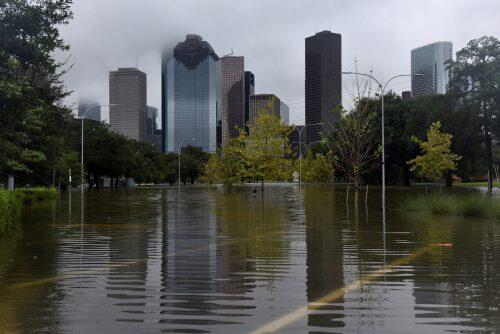 The downtown skyline is reflected in the flood water at Buffalo Bayou Park after Hurricane Harvey inundated the Texas Gulf coast with rain causing widespread flooding, in Houston, Texas, U.S. August 27, 2017. REUTERS/Nick Oxford